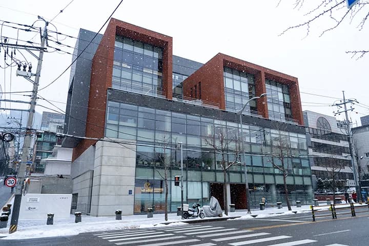 Exterior of the D.CAMP building on a snowy day